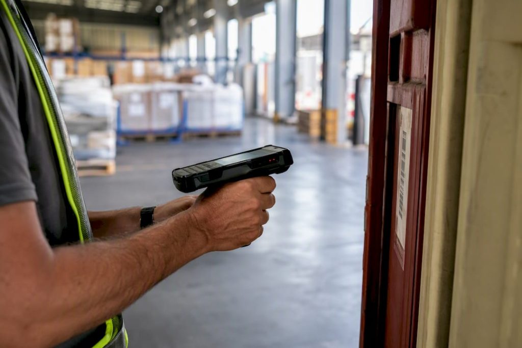 Worker scanning shipping container barcode