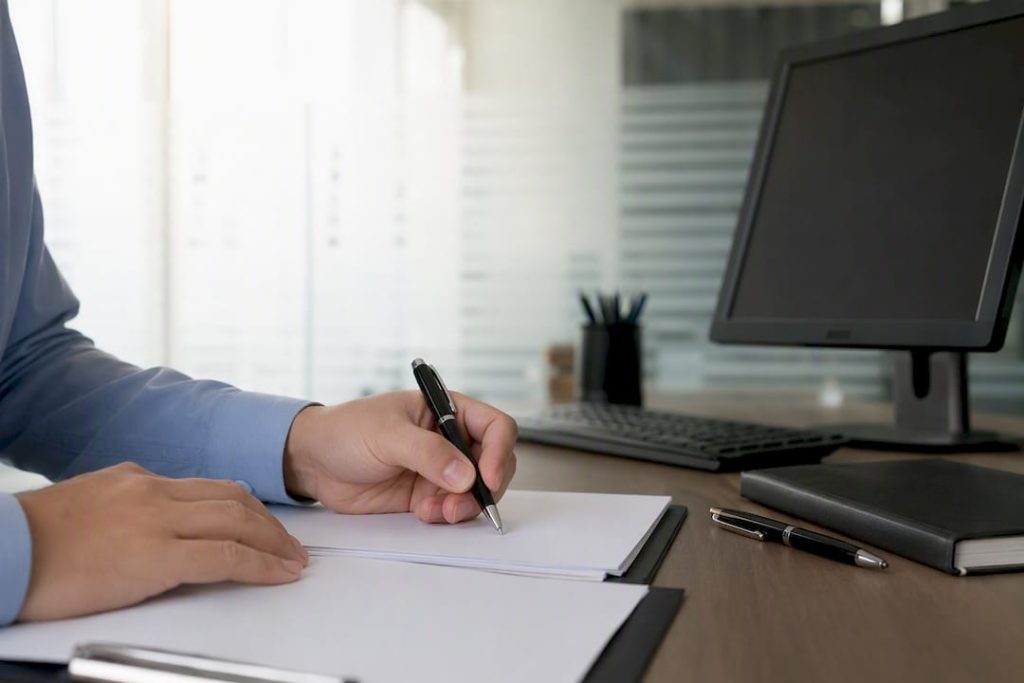 Hands preparing customs power of attorney form