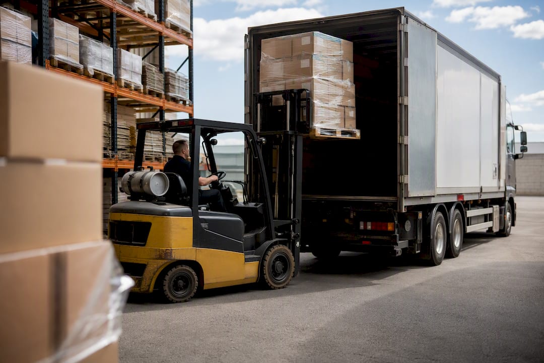 Pallet loaded into semi-trailer truck at dock