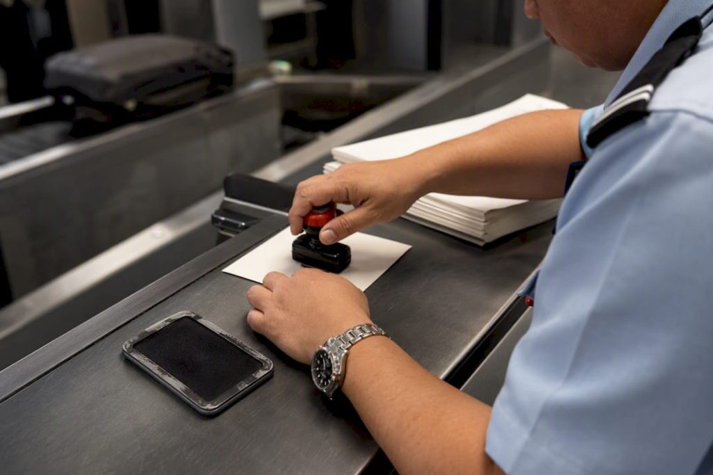 Hands stamping customs clearance certificate