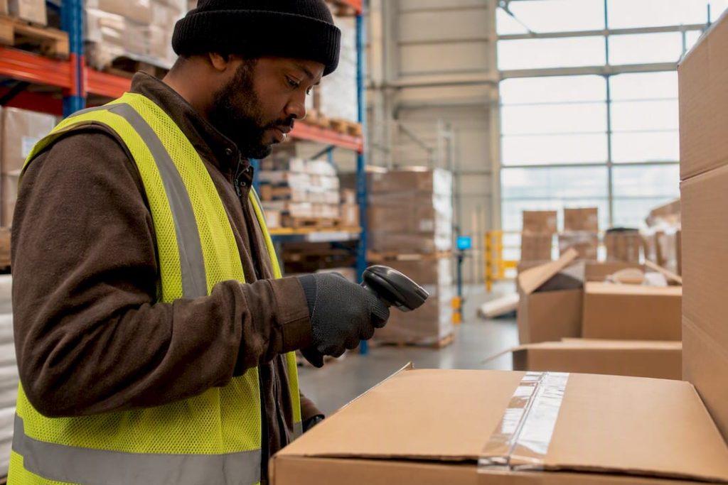 Worker scanning freight shipment labels